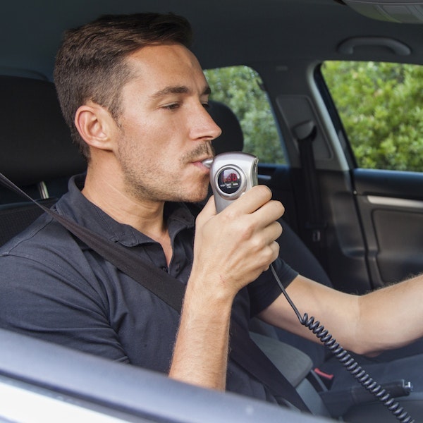 Man blowing in breathalyzer
