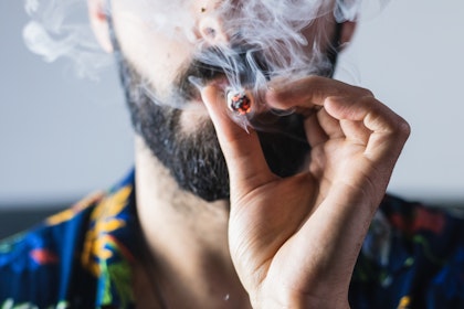 close-up of man smoking a joint