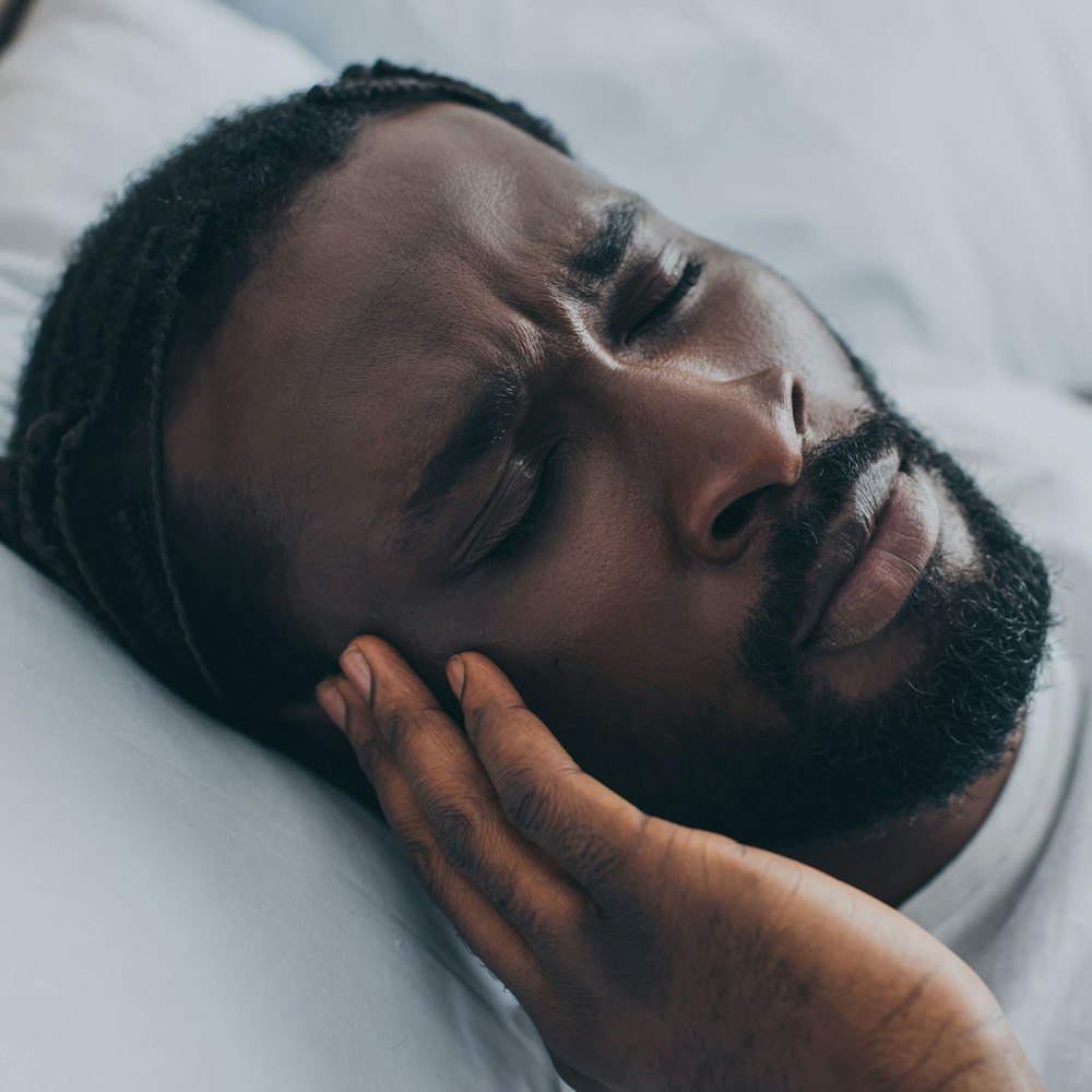 Man with headache in bed