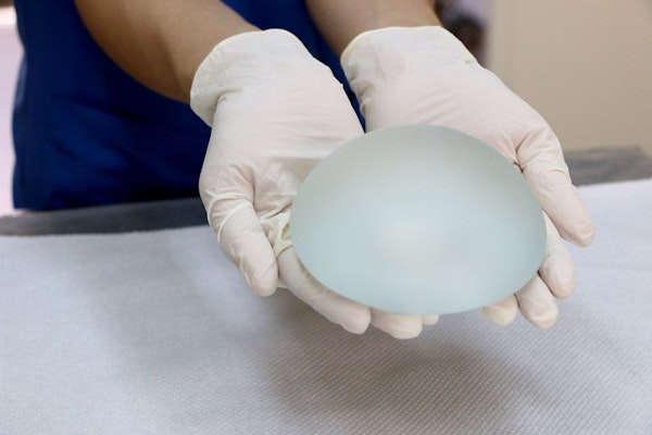 Breast implant in gloved hands