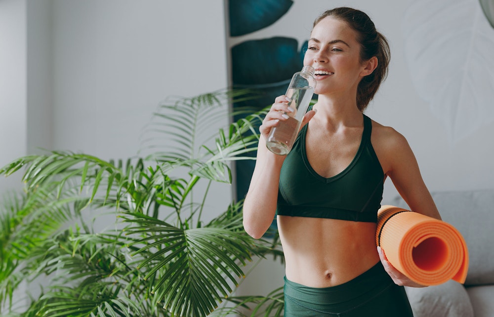 Woman holding yoga mat