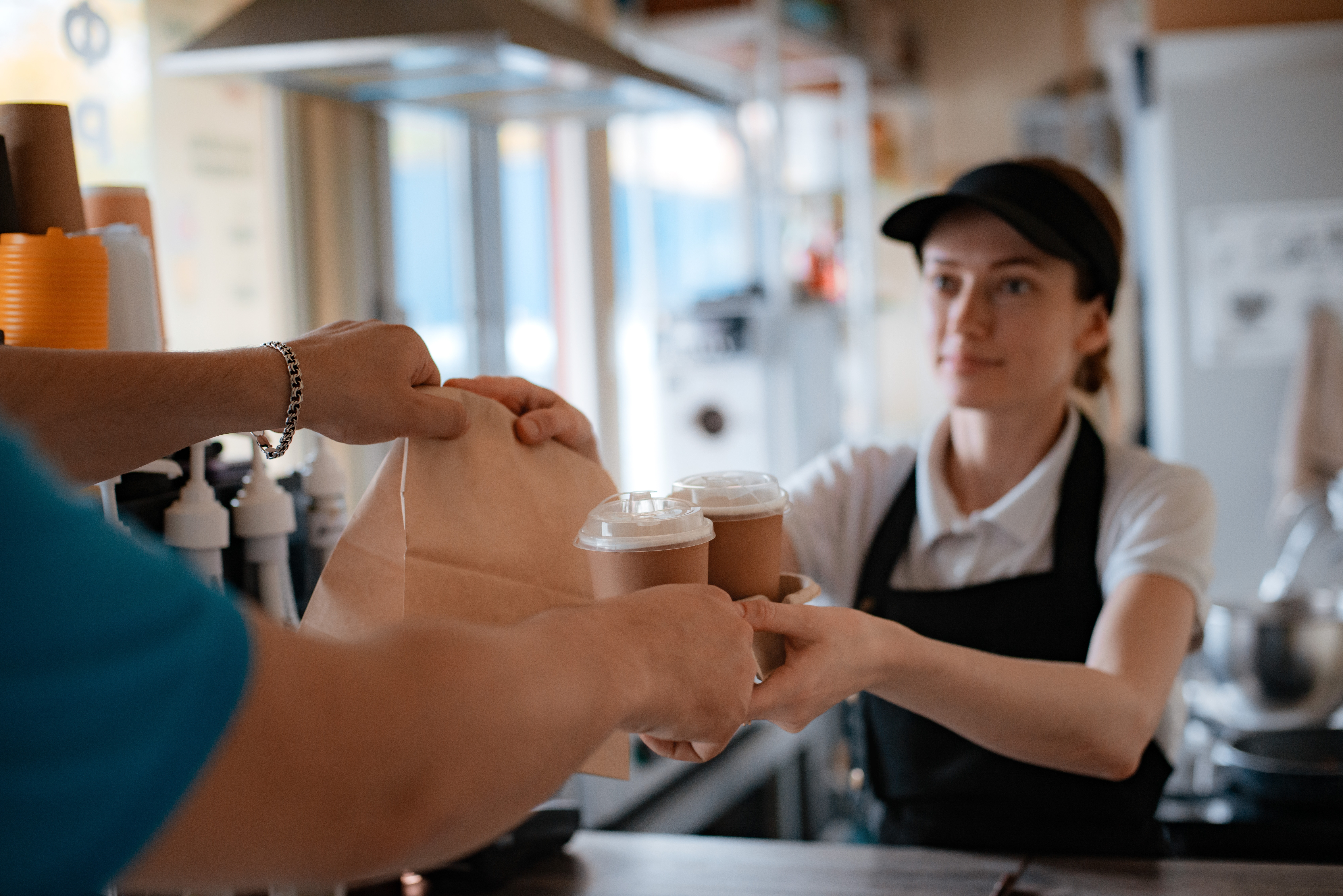 Barista handing man his order