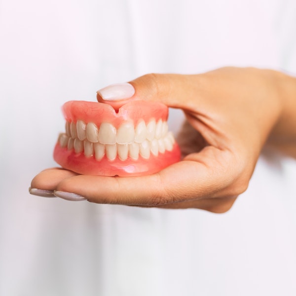 Person holding dentures