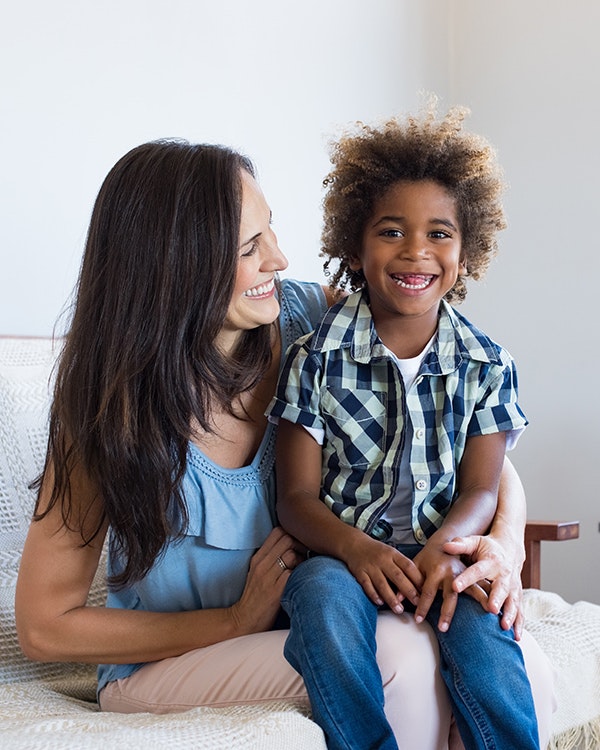 Smiling adopted boy with mother