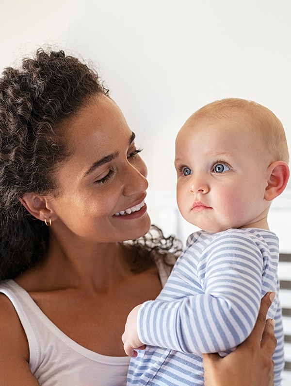 Smiling mom holding adopted baby