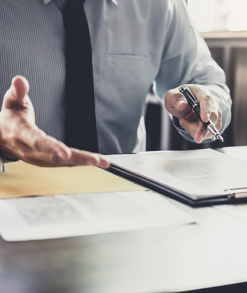 a consultant's hand at his desk
