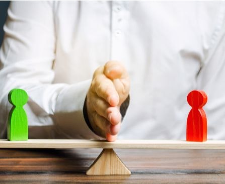 image of a balance with two people on other side