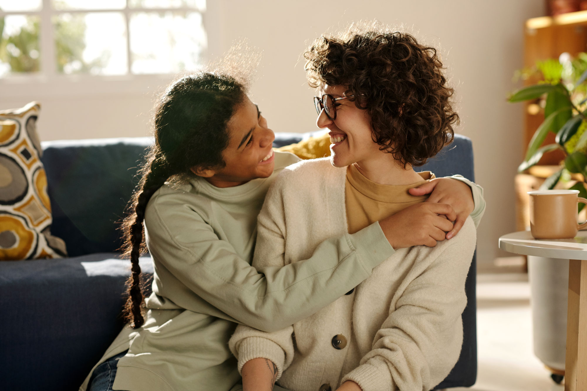 Daughter hugging mother and smiling