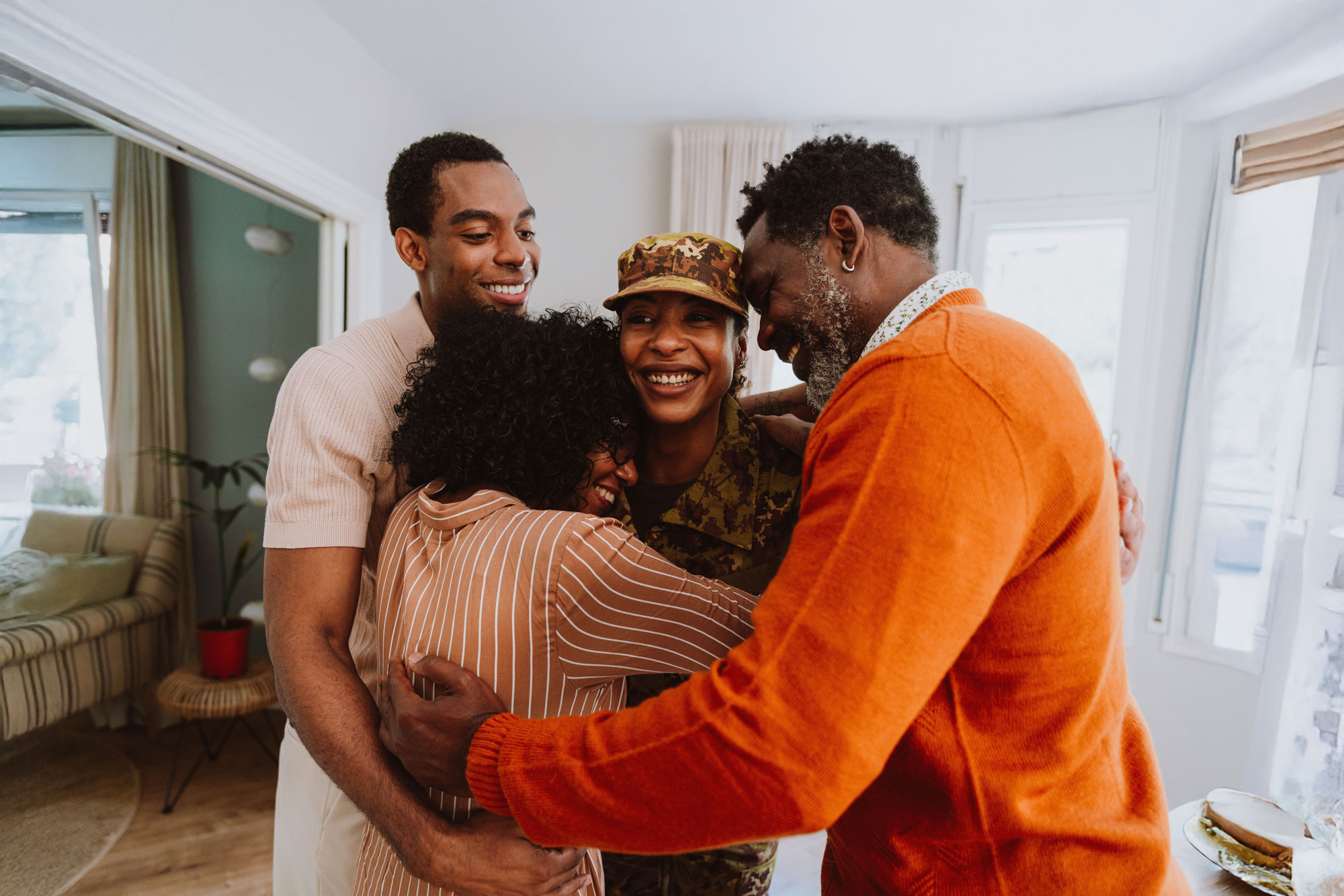 Happy group welcoming deployed family member home
