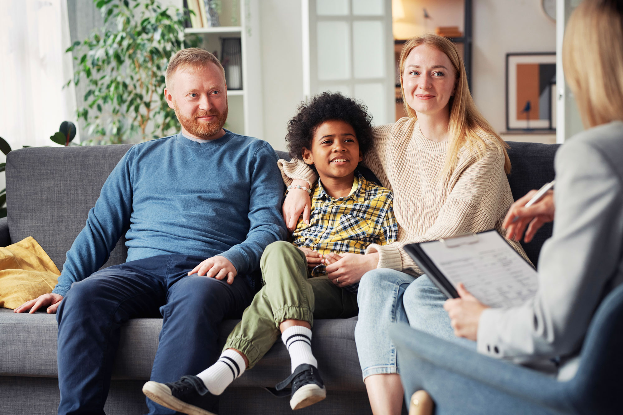Adopted child with parents and counselor
