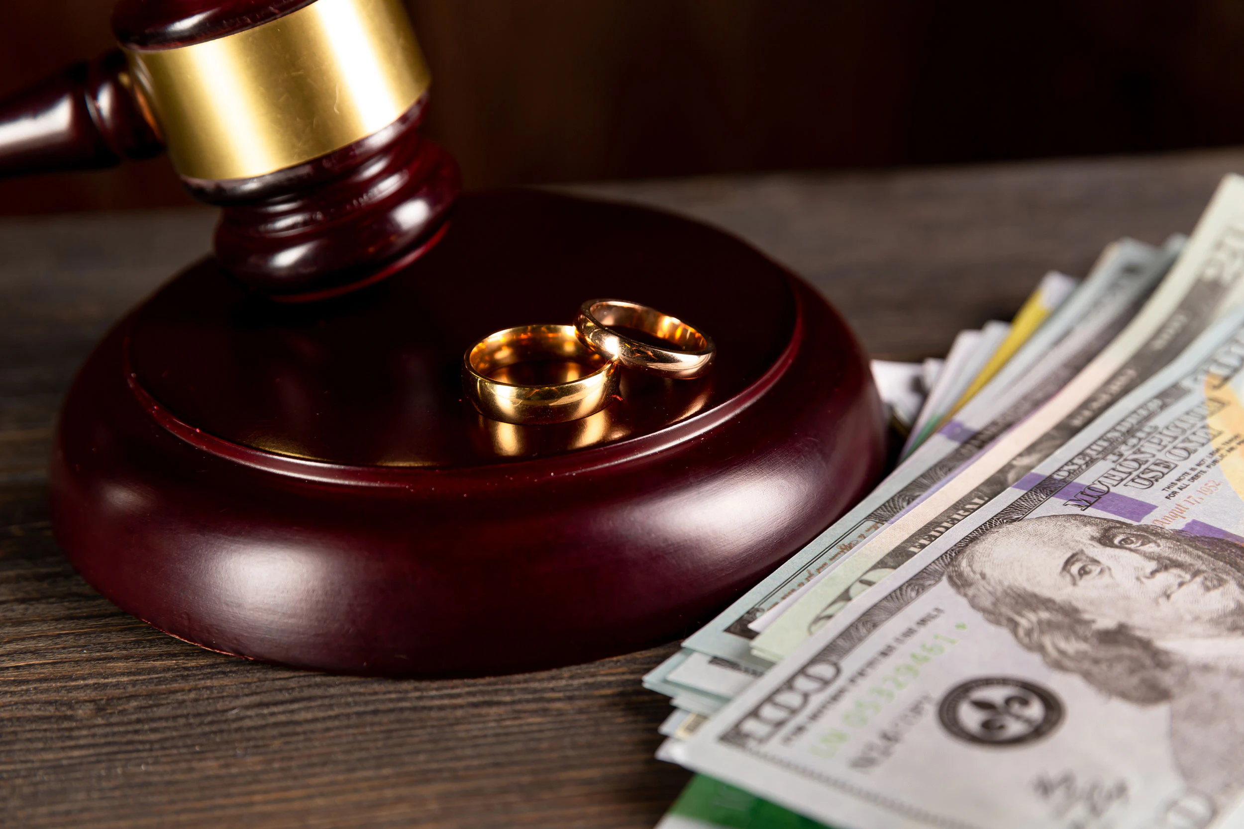 Gavel with wedding rings and money