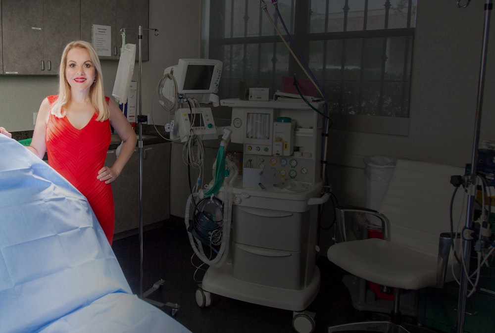 Dr. Barone in red dress in operatory