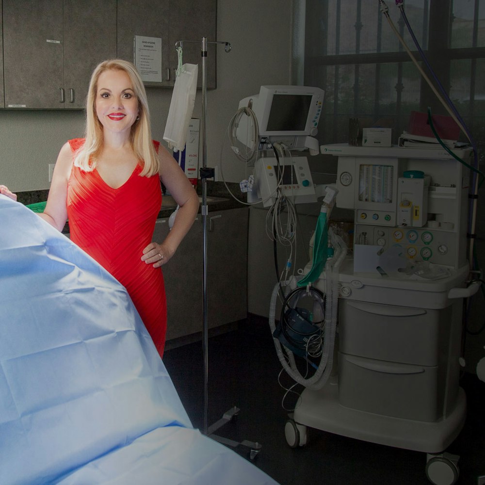 Dr. Barone in red dress in operatory