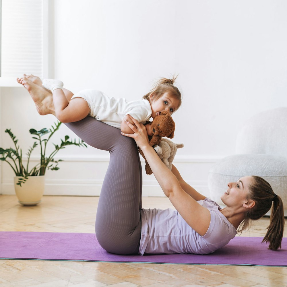 mother doing yoga with her baby