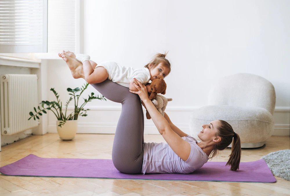 mother doing yoga with her baby