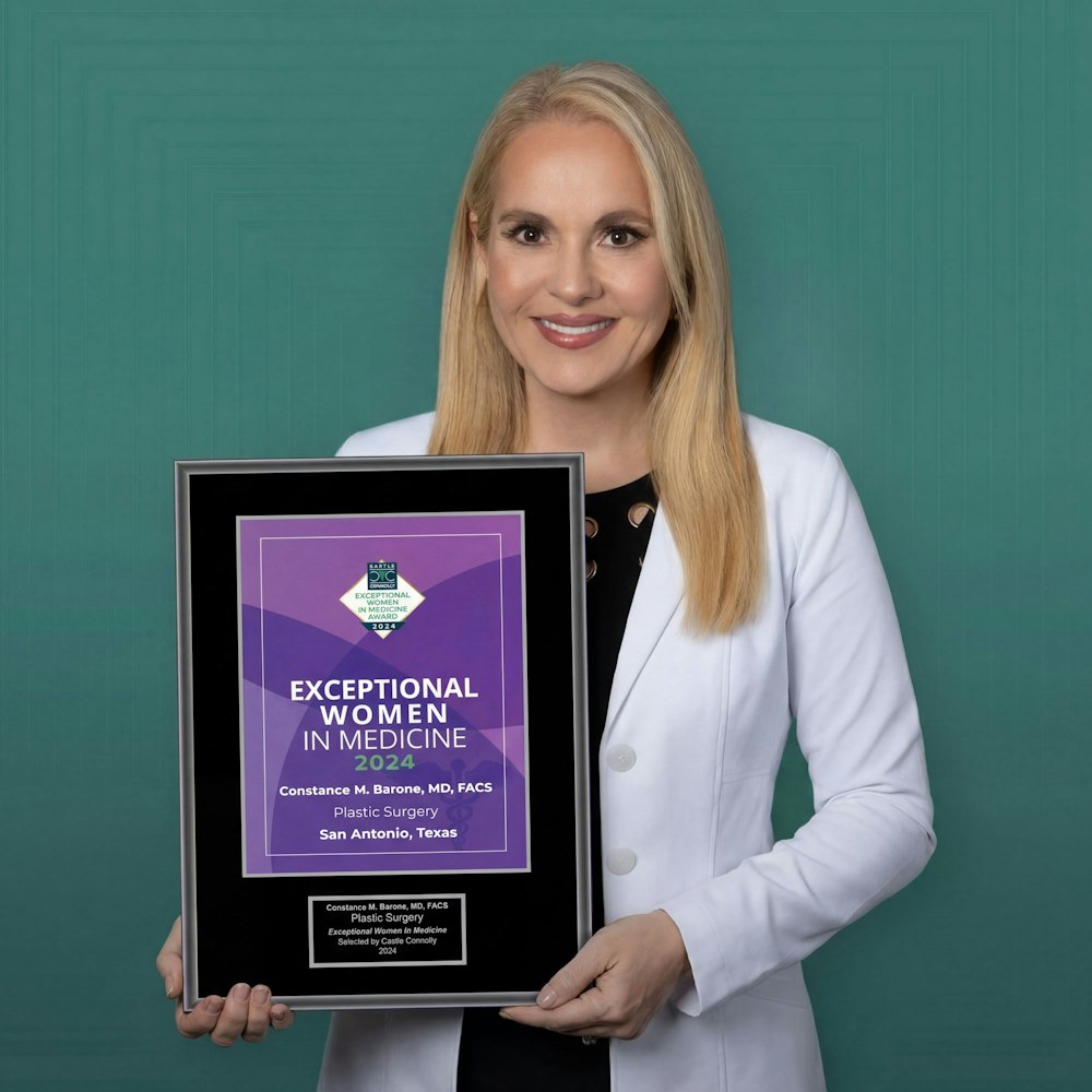 Dr. Constance Barone holding award