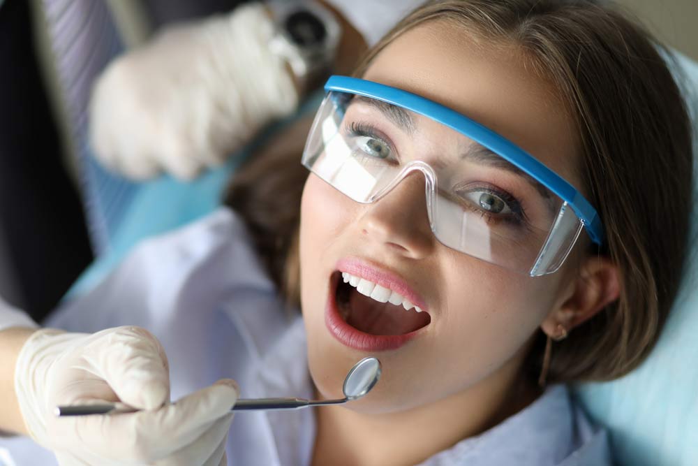 Woman getting teeth examined
