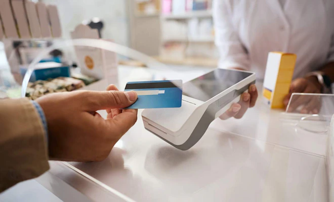Patient using a credit card to pay at a front desk