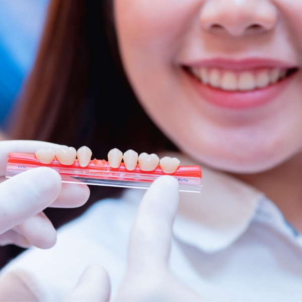 Dentist showing patient multiple dental crown options