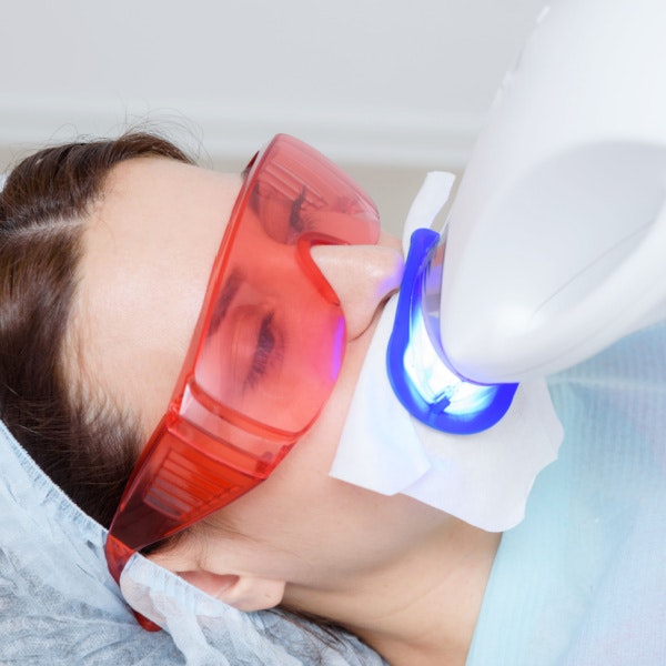 Girl receiving in-office teeth whitening treatment