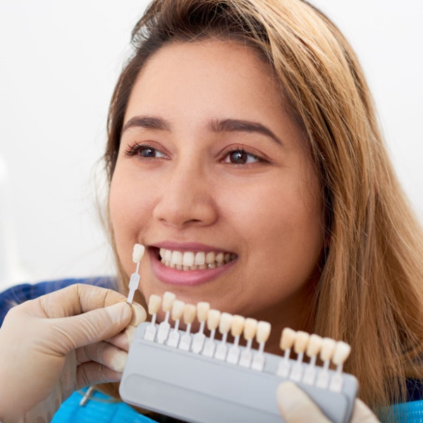 Female patient getting shade matched for veneers