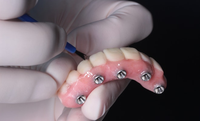 Technician crafting a denture