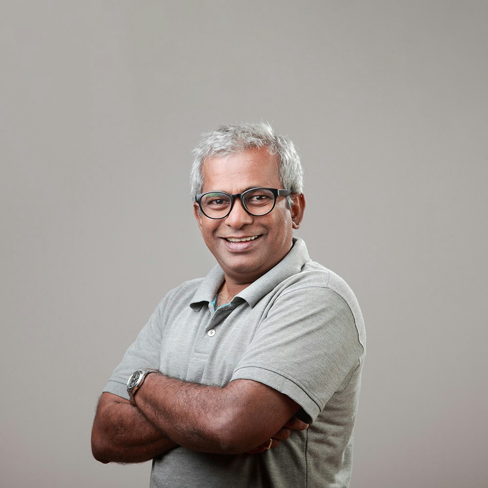 Man smiling with arms crossed