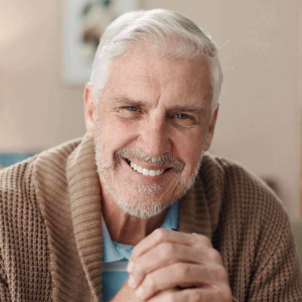 smiling man in cardigan