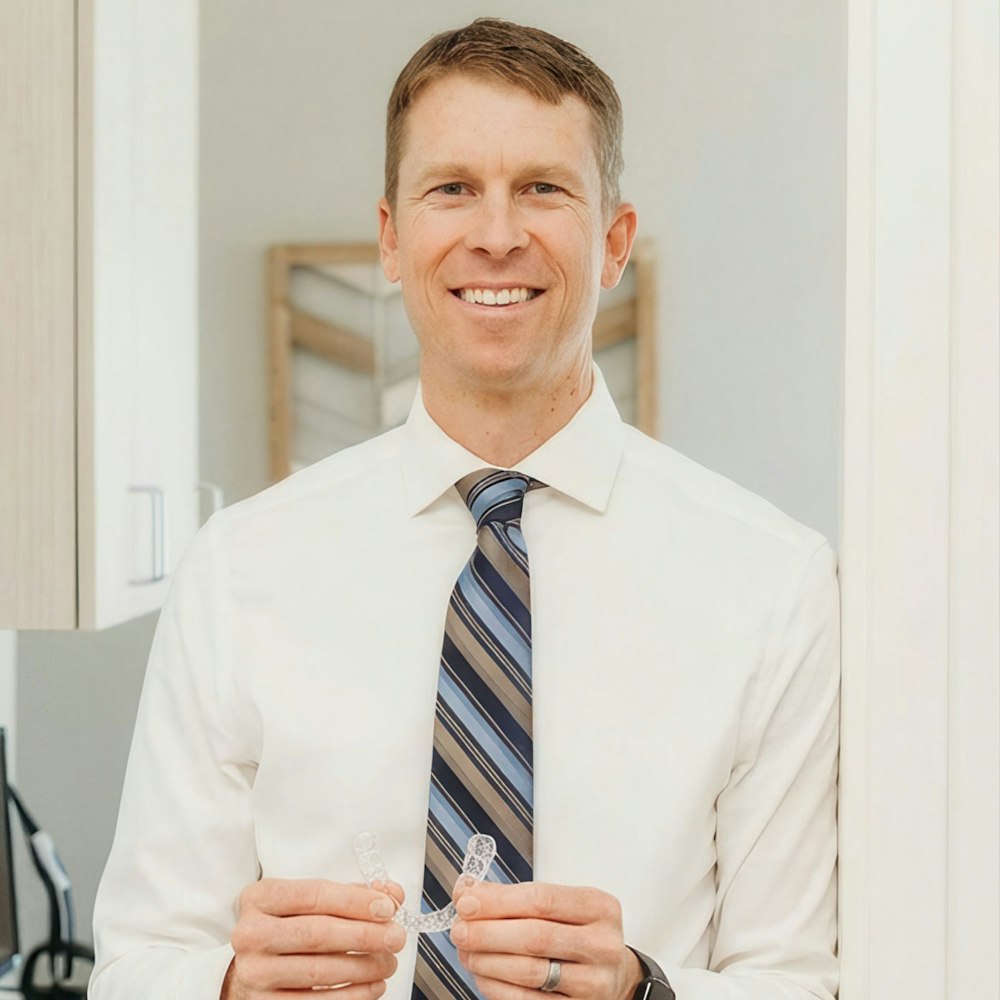 Dr. Maples holding a clear aligner