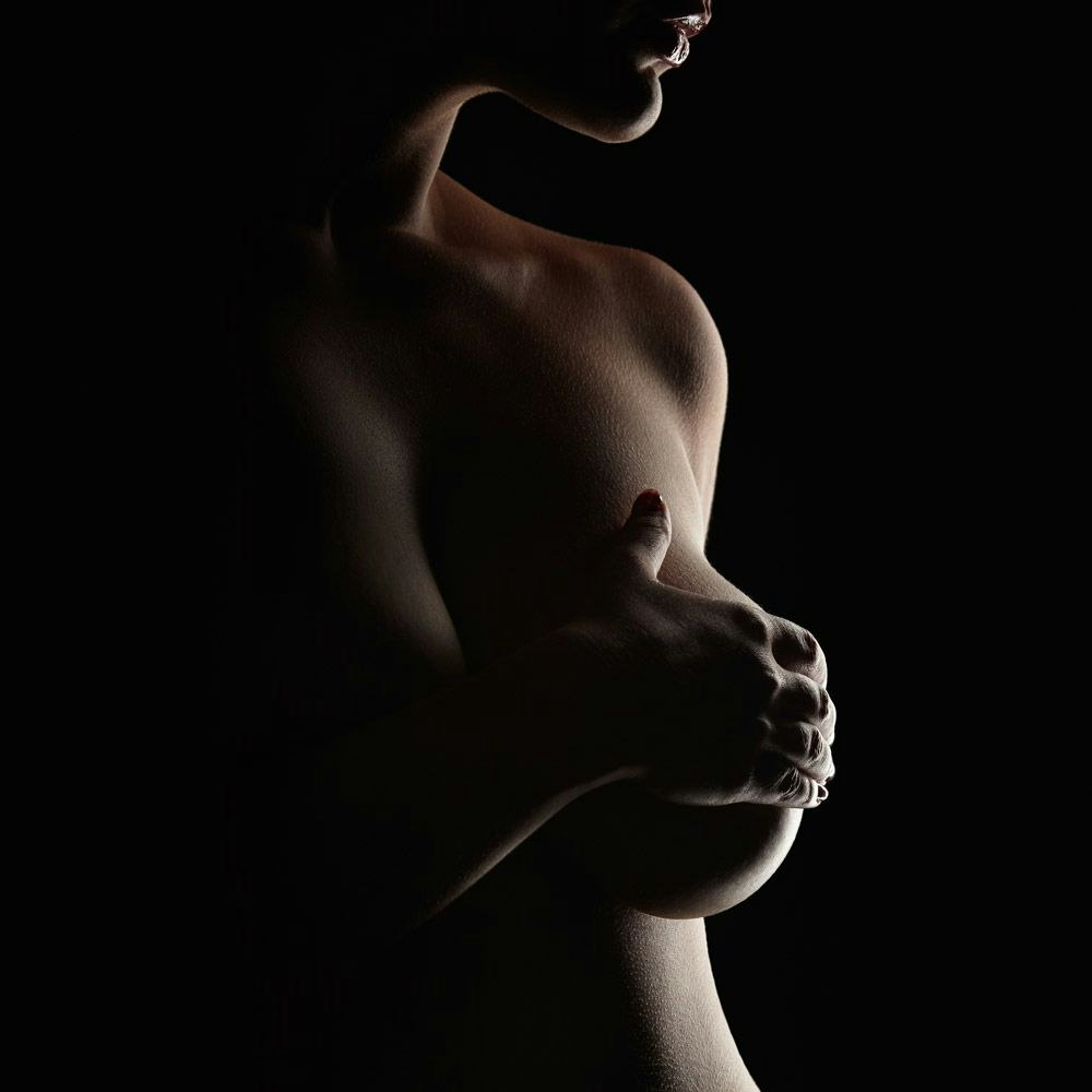 Woman with hand over breast