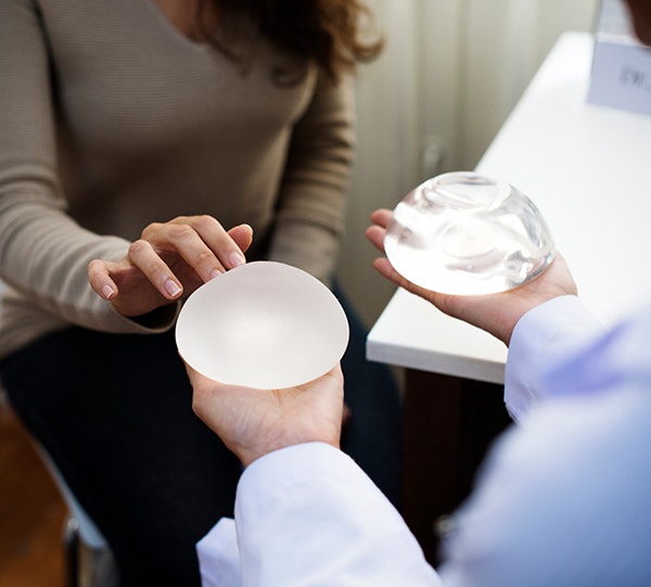 Patient comparing silicone and saline implants