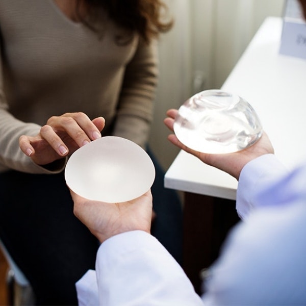 Doctor presenting breast implants to patient