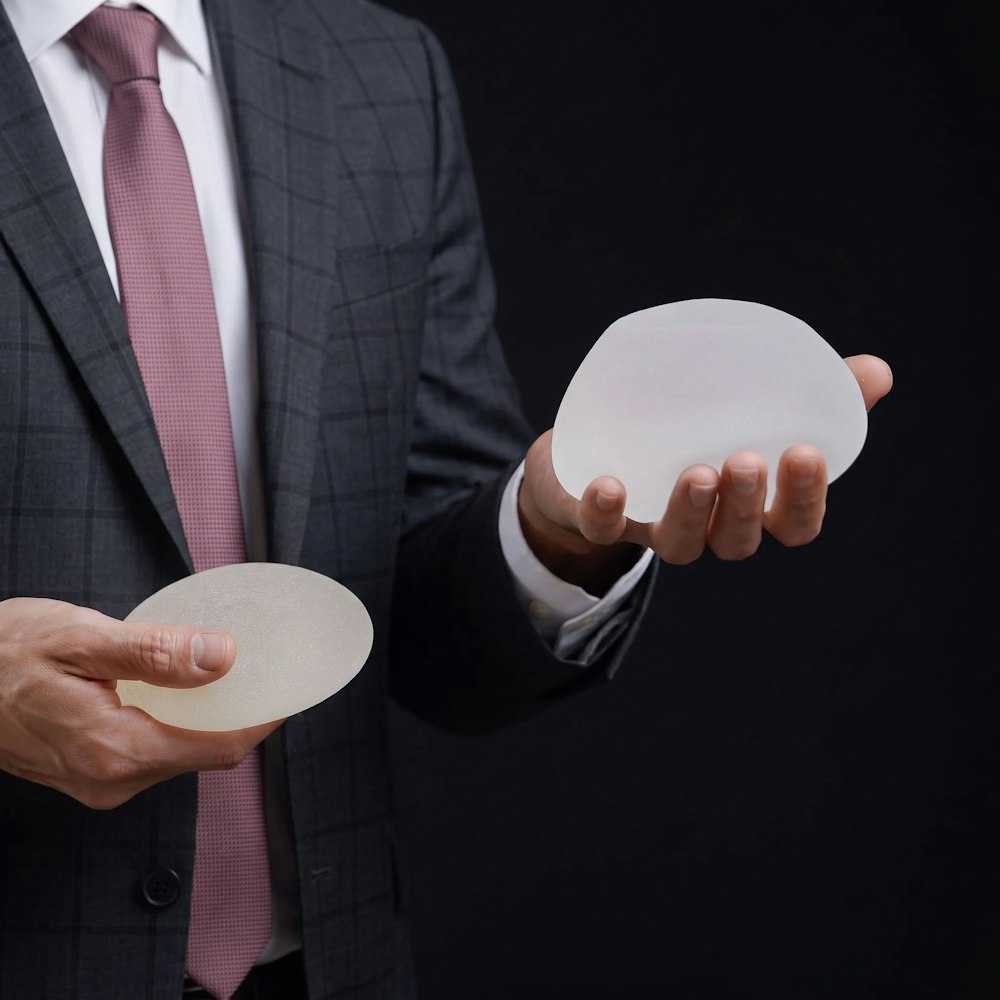 Dr. Tandon holding breast implants