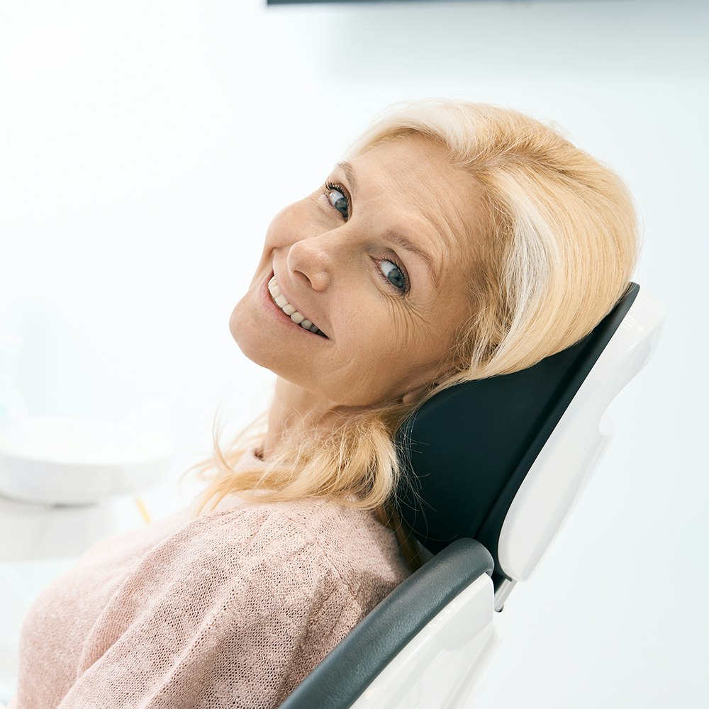 smiling woman in dental chair