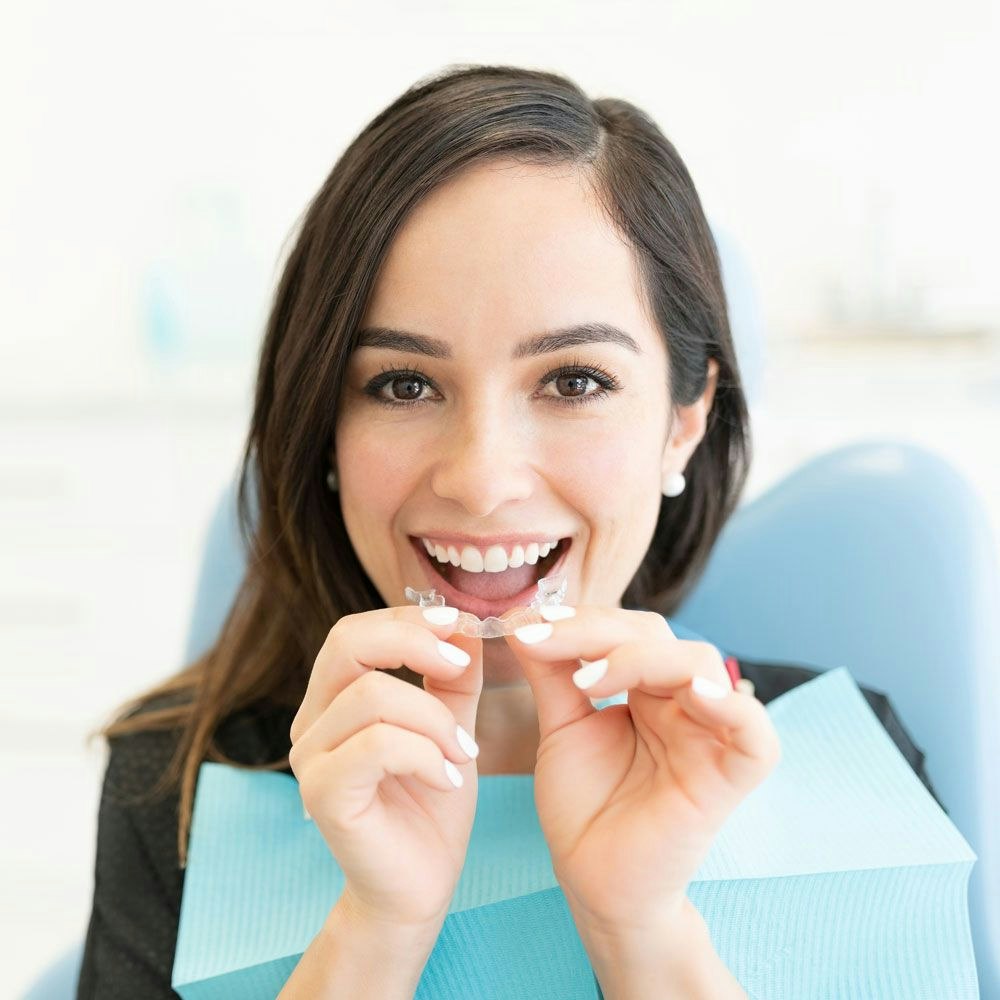 Woman putting in a clear aligner