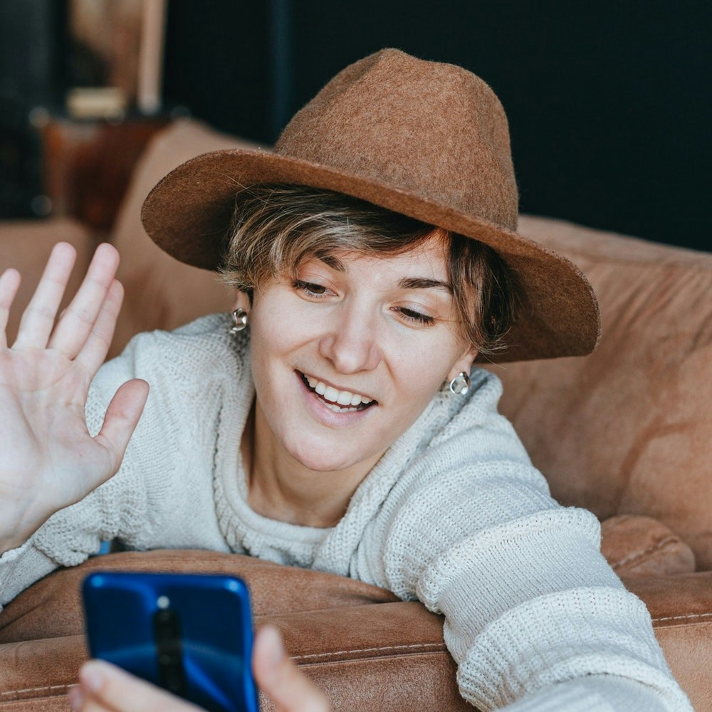 Woman smiling while having a video chat on her phone