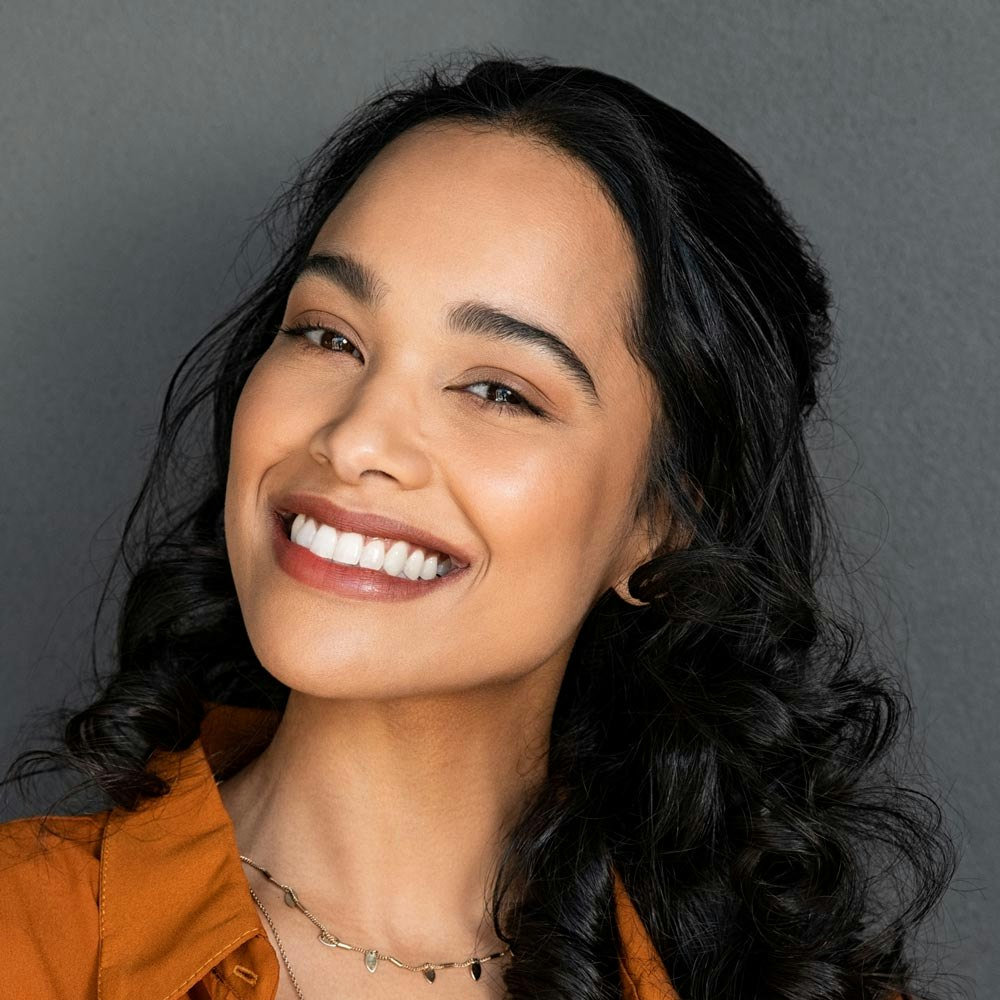 Woman in bathing suit smiling at camera
