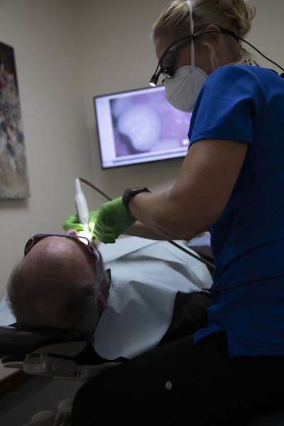 Hygienist cleaning teeth