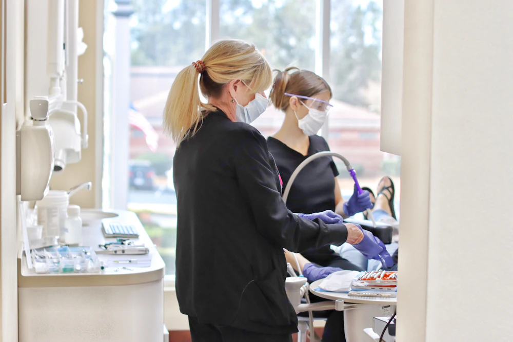 hygienists with patient during appointment