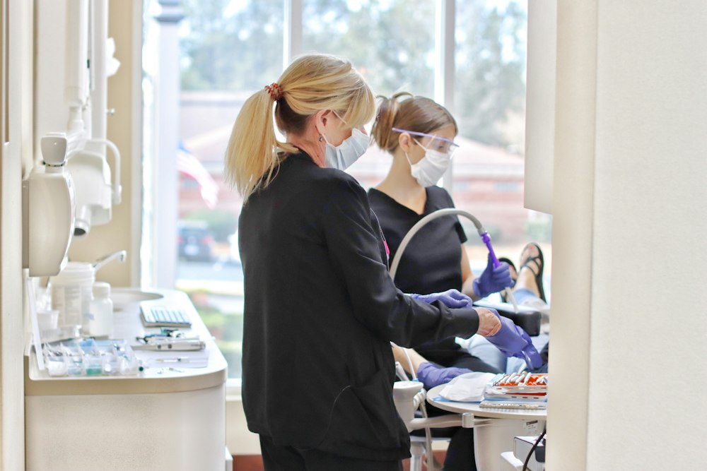 hygienists with patient during appointment