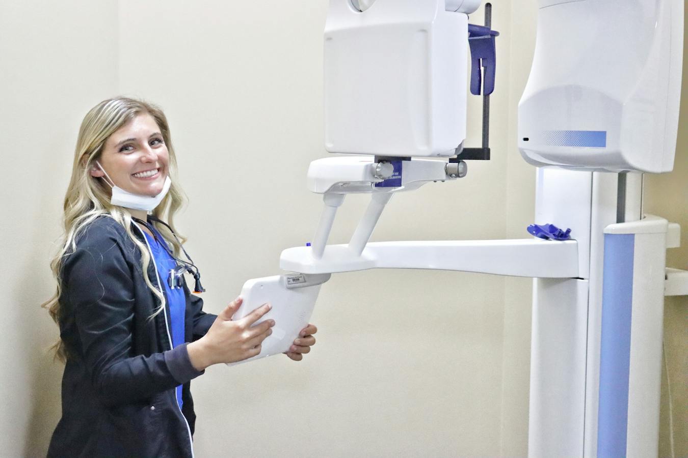 smiling hygienist with 3D cone scanner