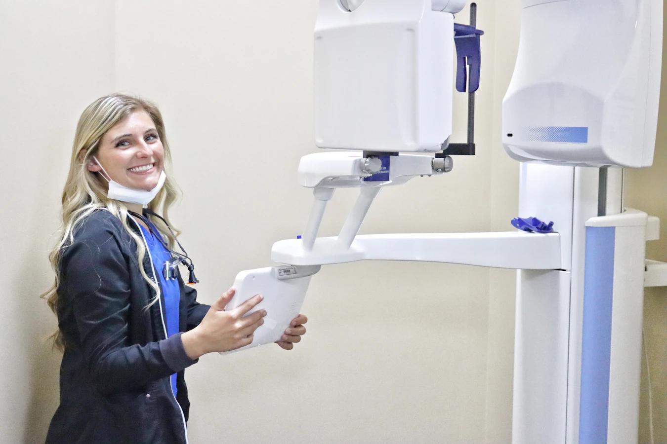 smiling hygienist with 3D cone scanner