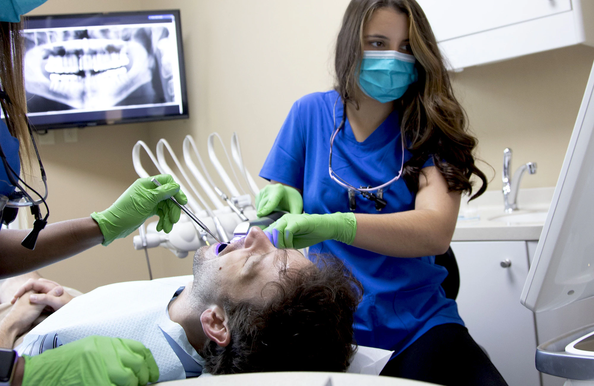 dental team and patient during an exam