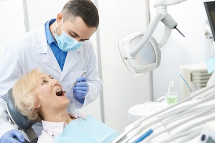 Mature woman getting her teeth examined at the dentist