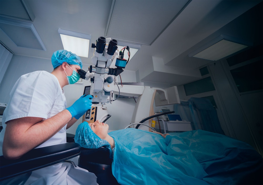 Eye doctor working on patient