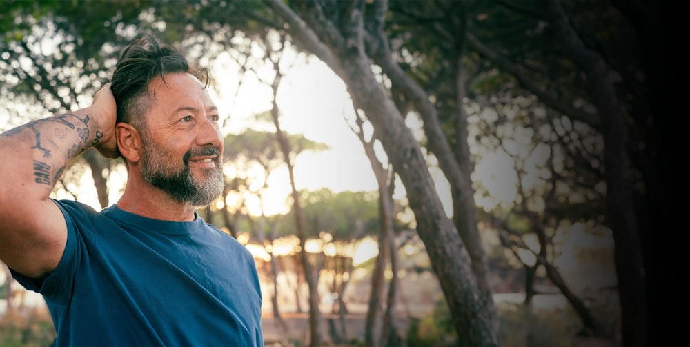 Couple holding binoculars smiling at each other