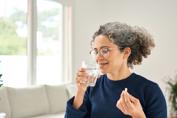 Woman taking oral medication