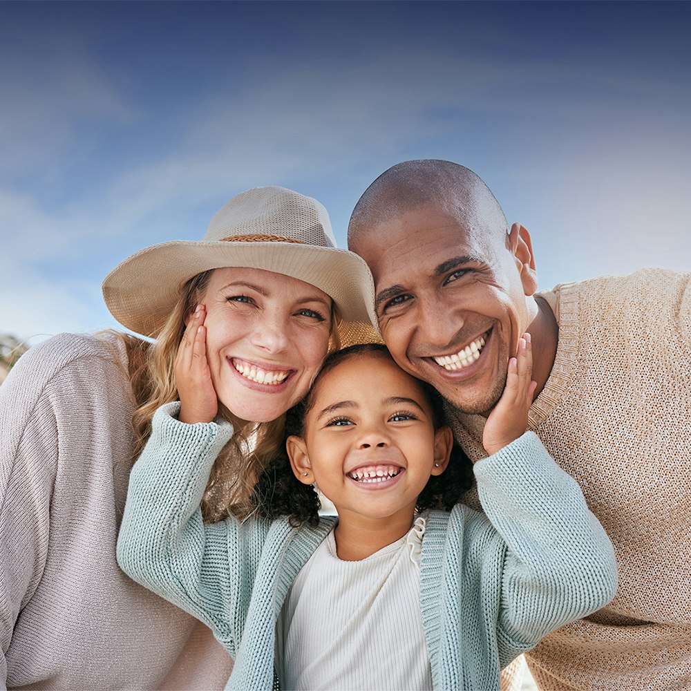 smiling mother, father, and daughter