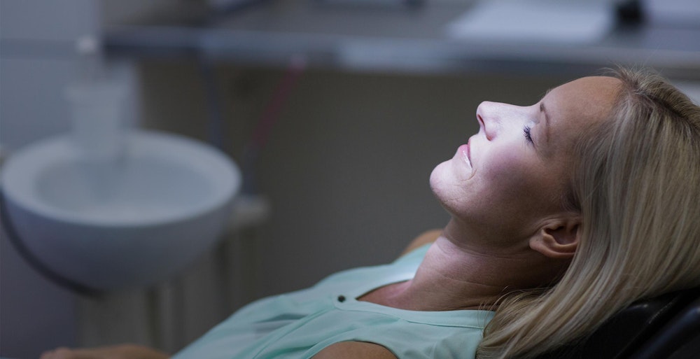 Woman sitting in dental treatment chair