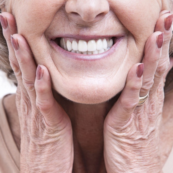 closeup shot of a mature woman showing a bright, even smile